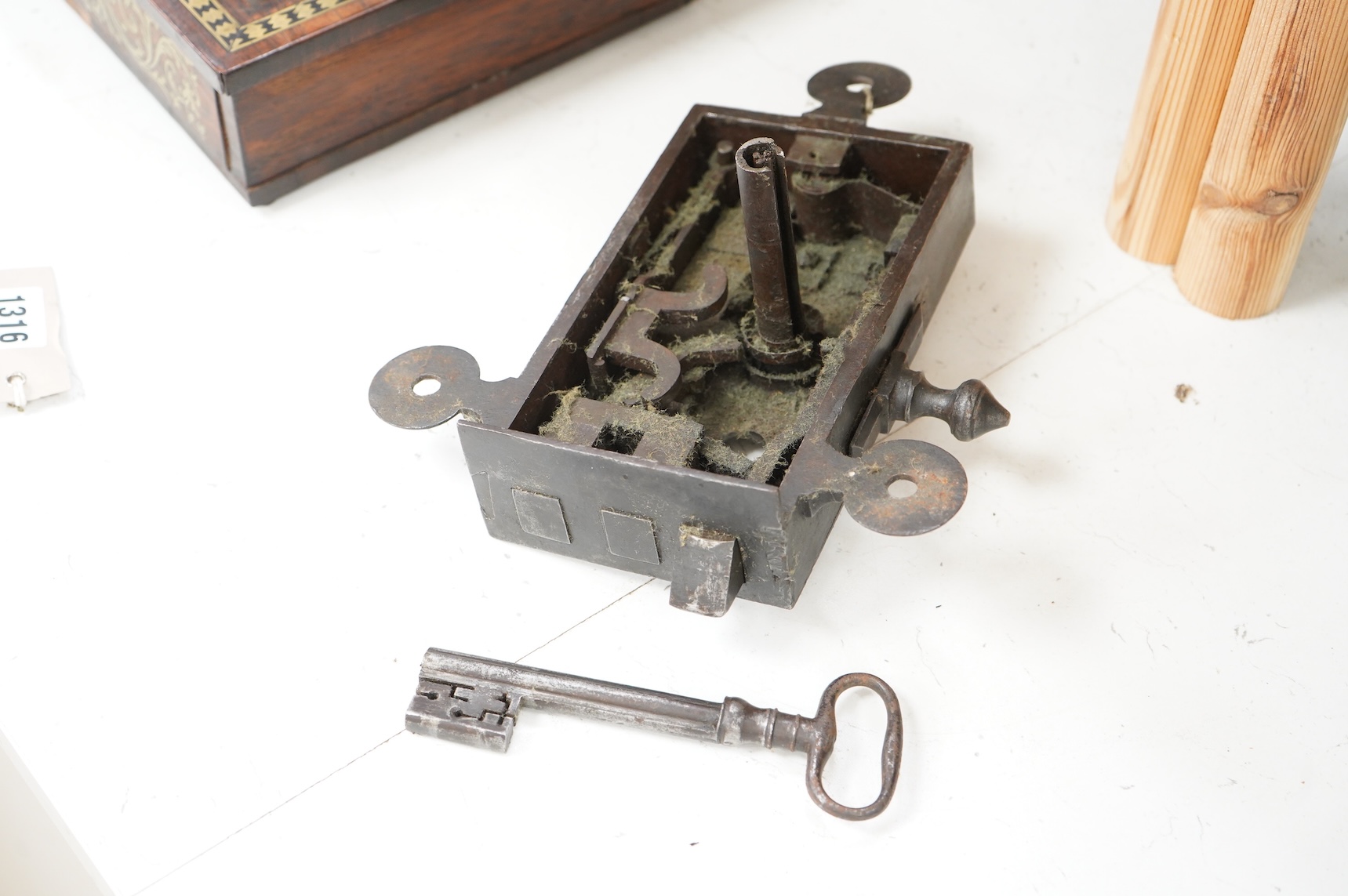 A 17th century steel door lock and key, lock 24cm wide.
